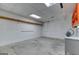 Unfinished basement, ready for customization, featuring concrete floor and blank walls with orange shelving at 3700 Tom Brewer Rd, Loganville, GA 30052
