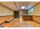 Spacious basement area with terracotta tile flooring, a bar area, and unique patterned wallpaper at 3700 Tom Brewer Rd, Loganville, GA 30052