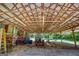 Interior view of carport filled with tractor, ladder, and various equipment and supplies at 3700 Tom Brewer Rd, Loganville, GA 30052