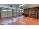 Spacious garage with three car doors, painted brick wall and ample room for parking and storage at 3700 Tom Brewer Rd, Loganville, GA 30052