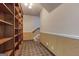 Hallway with wainscoting leading to carpeted stairs, featuring a large built-in wooden bookcase at 3700 Tom Brewer Rd, Loganville, GA 30052