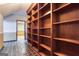 View of a hallway with a large built-in wooden bookcase and tile flooring leading to another room at 3700 Tom Brewer Rd, Loganville, GA 30052
