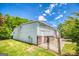 Metal building featuring a fenced in entrance, brick foundation, and green lawn at 3700 Tom Brewer Rd, Loganville, GA 30052