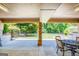 Covered patio with a brick column overlooks a lush yard, offering a serene outdoor living space at 3700 Tom Brewer Rd, Loganville, GA 30052