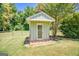 Exterior view of shed with door, surrounded by green lawn and trees at 3700 Tom Brewer Rd, Loganville, GA 30052