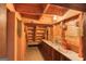 Unfinished storage room shows exposed beam construction and a built-in shelf perfect for storage at 3700 Tom Brewer Rd, Loganville, GA 30052