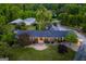 Aerial view of a home showcasing its brick facade, well-manicured lawn, and surrounding lush landscaping at 3700 Tom Brewer Road, Loganville, GA 30052