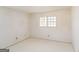 A bright, unfinished bedroom space features white walls, simple window, and ample natural light at 2571 Beech St, Morrow, GA 30260
