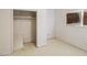 Bedroom features white walls, an empty closet, and covered window awaiting remodel at 2571 Beech St, Morrow, GA 30260