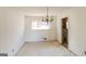 Bright dining room featuring a chandelier, natural light from the window, and neutral-toned walls and flooring, showing renovation potential at 2571 Beech St, Morrow, GA 30260