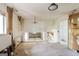 Sunlit living room with exposed beams, chandelier, and window to a bright day, showing potential for renovation and upgrades at 2571 Beech St, Morrow, GA 30260