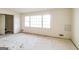 Living room featuring multiple windows for natural light, a door to the outside, and neutral-toned walls and flooring, ready for renovation at 2571 Beech St, Morrow, GA 30260