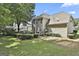 Expansive backyard with lush landscaping, deck, grill, and dining area provides a serene outdoor escape at 139 Ardenlee Dr, Peachtree City, GA 30269