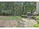 Expansive backyard with lush landscaping, wooden deck, and swing provides a serene outdoor escape at 139 Ardenlee Dr, Peachtree City, GA 30269