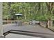 Spacious wooden deck with outdoor seating, grill, and wooded views creates an ideal space for entertaining at 139 Ardenlee Dr, Peachtree City, GA 30269