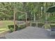 Wooden deck features a charming swing and railings, offering an inviting outdoor retreat at 139 Ardenlee Dr, Peachtree City, GA 30269