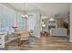 Bright dining area with modern chandelier and view into the living room with fireplace at 139 Ardenlee Dr, Peachtree City, GA 30269