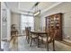 Bright dining room featuring a modern chandelier, a spacious table with seating, and an elegant china cabinet at 139 Ardenlee Dr, Peachtree City, GA 30269