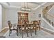 Elegant dining room with a modern chandelier, a large dining table, and a classic china cabinet for sophisticated living at 139 Ardenlee Dr, Peachtree City, GA 30269