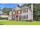 Inviting two-story home showcasing a brick and siding exterior, complemented by a well-kept lawn and an attached two-car garage at 139 Ardenlee Dr, Peachtree City, GA 30269
