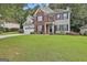 Beautiful two-story home with manicured lawn, featuring a brick facade, siding, and attached garage at 139 Ardenlee Dr, Peachtree City, GA 30269