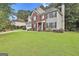 Gorgeous two-story home with a lush green lawn, a brick and siding exterior, and a convenient attached garage at 139 Ardenlee Dr, Peachtree City, GA 30269