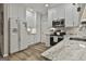 Contemporary kitchen featuring white cabinetry, stainless steel appliances, and granite countertops at 139 Ardenlee Dr, Peachtree City, GA 30269