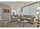Open living room with a view into the kitchen, comfortable seating, and hardwood floors at 139 Ardenlee Dr, Peachtree City, GA 30269