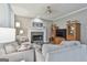 Cozy living room with a stone fireplace, neutral furniture, and hardwood floors at 139 Ardenlee Dr, Peachtree City, GA 30269