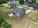Aerial view of a home featuring a backyard patio, fire pit, and well-manicured lawn in a suburban setting at 293 Ironwood Dr, Stockbridge, GA 30281