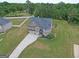An aerial view shows the house with long driveway and a manicured lawn at 293 Ironwood Dr, Stockbridge, GA 30281