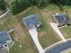 Spacious two-story home featuring a manicured lawn and an attached two-car garage, aerial view at 293 Ironwood Dr, Stockbridge, GA 30281