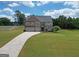 Beautiful two-story home features a large yard, long driveway, and three-car garage at 293 Ironwood Dr, Stockbridge, GA 30281
