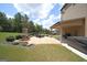 The home's backyard features a covered patio with a fireplace, an outdoor grill, and a hot tub at 293 Ironwood Dr, Stockbridge, GA 30281