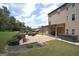 Beautifully landscaped backyard shows the home's covered patio with a fireplace and a hot tub at 293 Ironwood Dr, Stockbridge, GA 30281