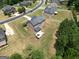 Aerial view of a backyard patio, a fire pit, and a manicured lawn in a residential neighborhood at 293 Ironwood Dr, Stockbridge, GA 30281