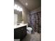 Well-lit bathroom features a vanity with sink, toilet, and shower with curtain at 293 Ironwood Dr, Stockbridge, GA 30281