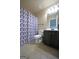 Bathroom with a tile floor, vanity, toilet and a shower with a decorative blue and grey shower curtain at 293 Ironwood Dr, Stockbridge, GA 30281