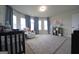 Bright Bedroom with neutral carpet, soft blue curtains, and a large window bay providing ample natural light at 293 Ironwood Dr, Stockbridge, GA 30281