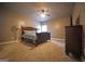 Cozy bedroom featuring plush carpet, ceiling fan, and stylish furniture at 293 Ironwood Dr, Stockbridge, GA 30281