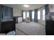 Comfortable Bedroom with neutral carpet, soft blue curtains, and large windows providing ample natural light at 293 Ironwood Dr, Stockbridge, GA 30281