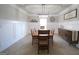 This dining room has a large wooden table, wainscoting, a modern chandelier and a tray ceiling at 293 Ironwood Dr, Stockbridge, GA 30281