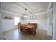 This dining room has a large wooden table, wainscoting, a modern chandelier and a tray ceiling at 293 Ironwood Dr, Stockbridge, GA 30281