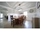 This dining room has a large wooden table, wainscoting, a modern chandelier and a tray ceiling at 293 Ironwood Dr, Stockbridge, GA 30281