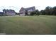 Spacious two-story home on a large lot with a well-manicured lawn and a three-car garage at 293 Ironwood Dr, Stockbridge, GA 30281