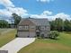 Spacious two-story brick home with manicured lawn, mature landscaping, and a two-car garage at 293 Ironwood Dr, Stockbridge, GA 30281