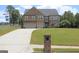 Beautiful two-story brick home with manicured lawn and two-car garage on a sunny day at 293 Ironwood Dr, Stockbridge, GA 30281