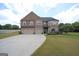 Beautiful two-story brick home featuring a manicured lawn and convenient two-car garage at 293 Ironwood Dr, Stockbridge, GA 30281