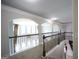 Carpeted hallway with railing, archways and access to rooms in the home at 293 Ironwood Dr, Stockbridge, GA 30281