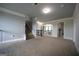 Bright hallway featuring carpet, stairs, archways, and access to multiple rooms at 293 Ironwood Dr, Stockbridge, GA 30281